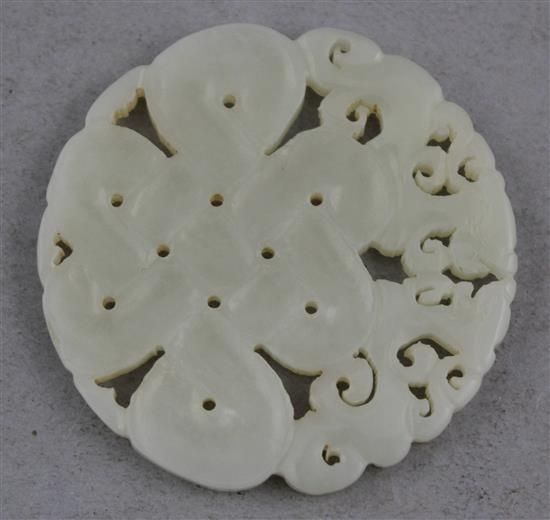 A Chinese celadon-white jade disc, 5.7cm.